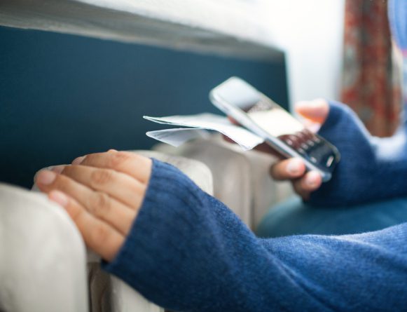 homeowner on the phone trying to get their energy bills lower while heating their home
