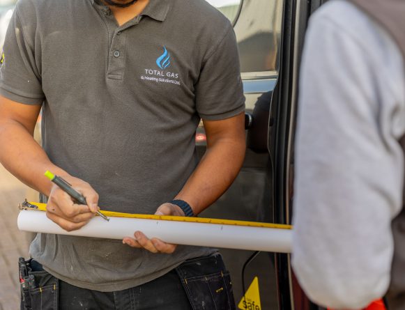 Total gas plumbing expert draws notches on a pipes prior to installing it into a residential home