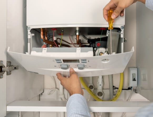 Combi boiler insides about to be closed and installation complete